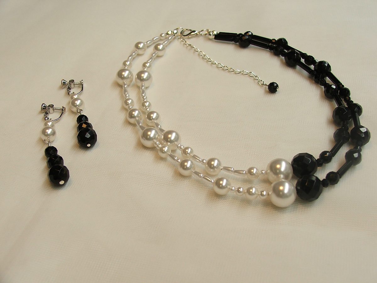 Two-strand pearl and black faceted bead necklace with matching earrings