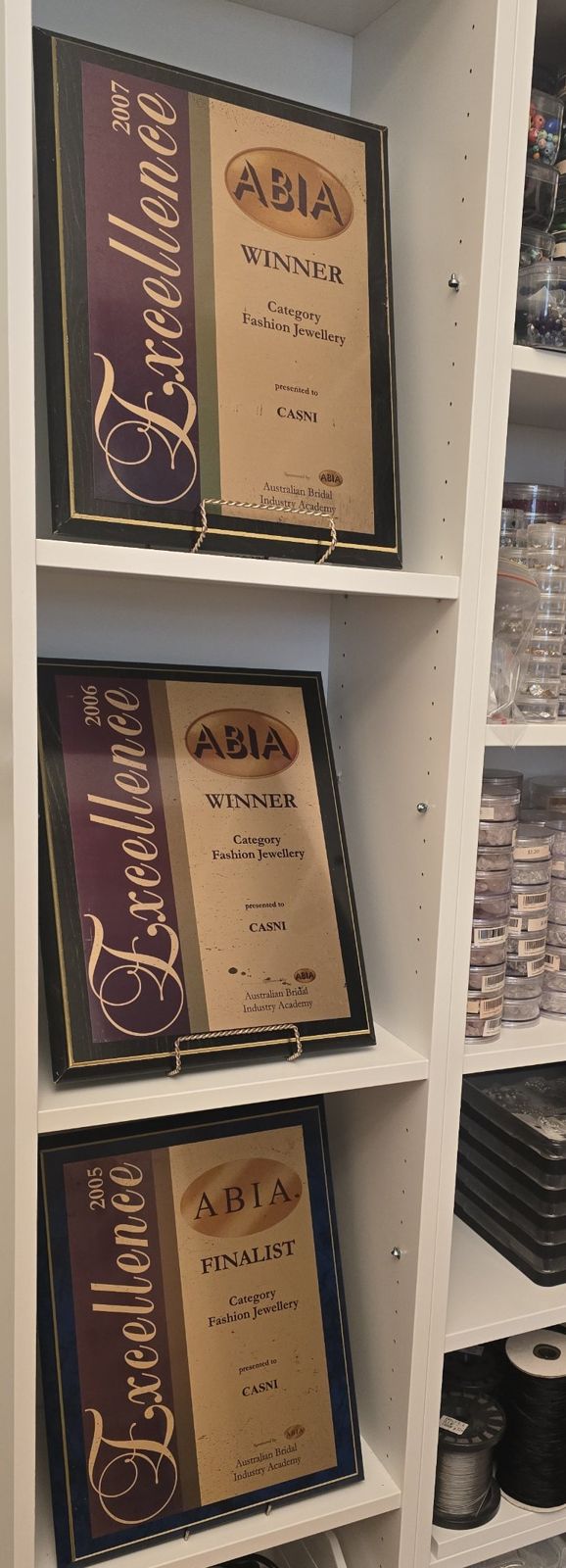 Three ABIA Excellence award plaques presented to Casni, 2005 to 2007, on the beading room shelves
