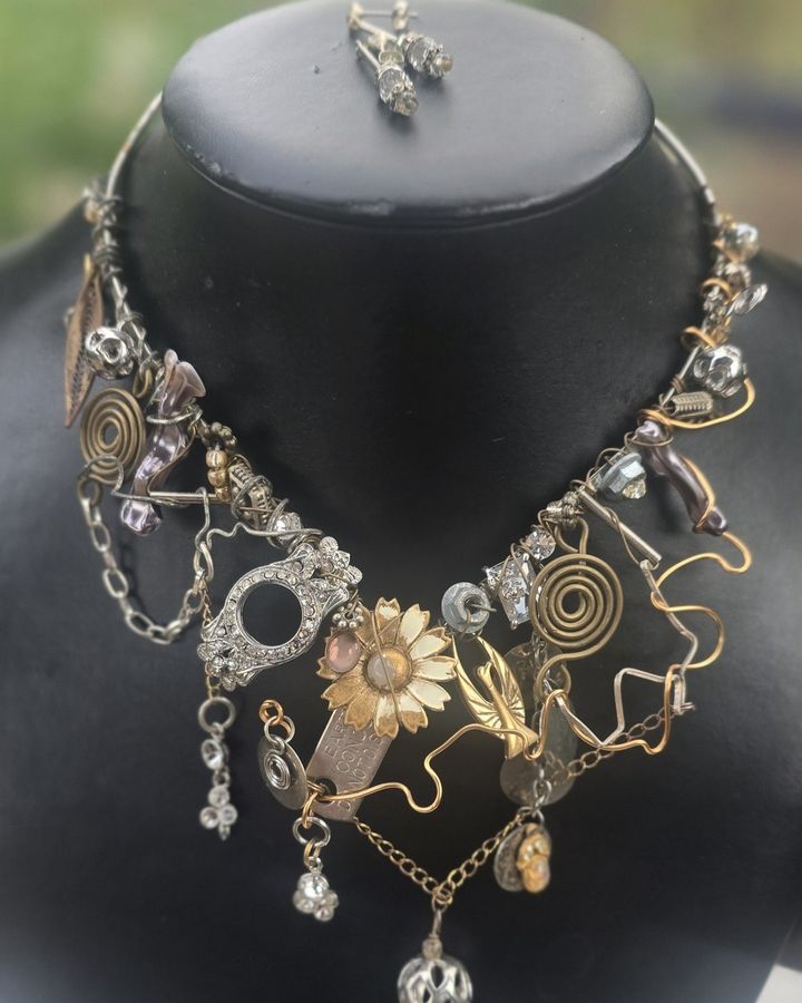 Metallicrystal with an enamel daisy, brass spirals and chain